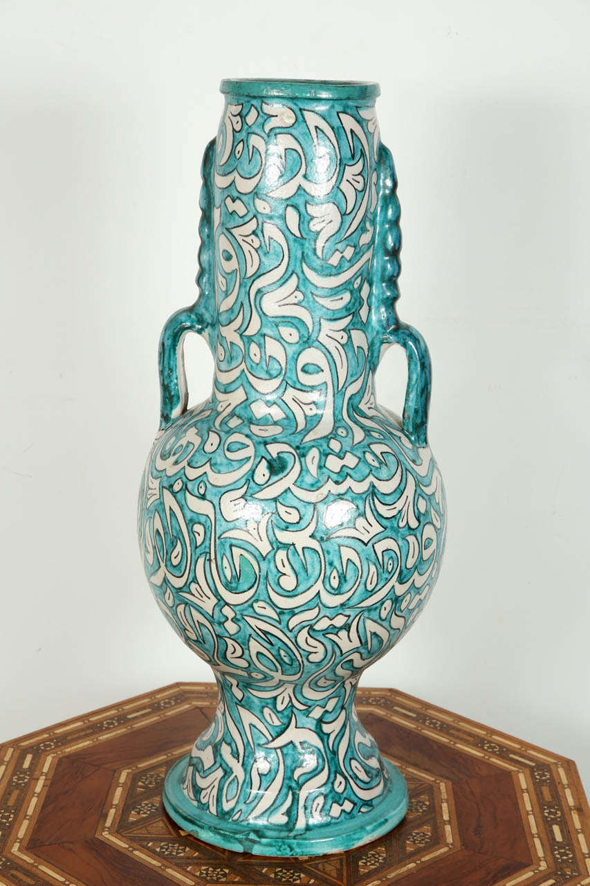 A large hand-crafted Hispano Moresque, Moroccan glazed ceramic vase.
Fabulous Arabic calligraphy writing designs in turquoise on cream background.
