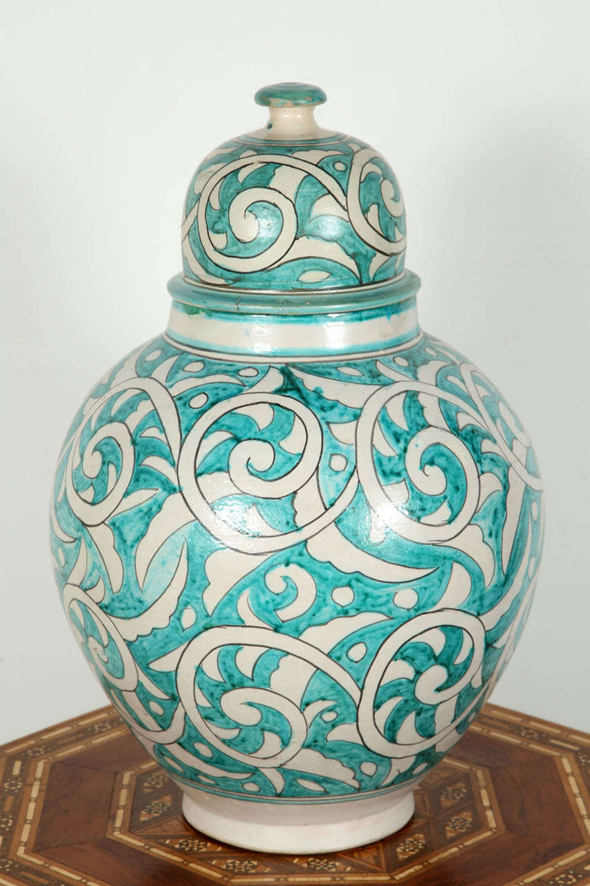 A large hand-crafted Moroccan glazed ceramic storage jar with with removable lid.
Moorish style designs in turquoise on cream background.

Mosaik provides Antiques in Moorish Style, Spanish, African, Islamic Art, Arabian, Middle Eastern,