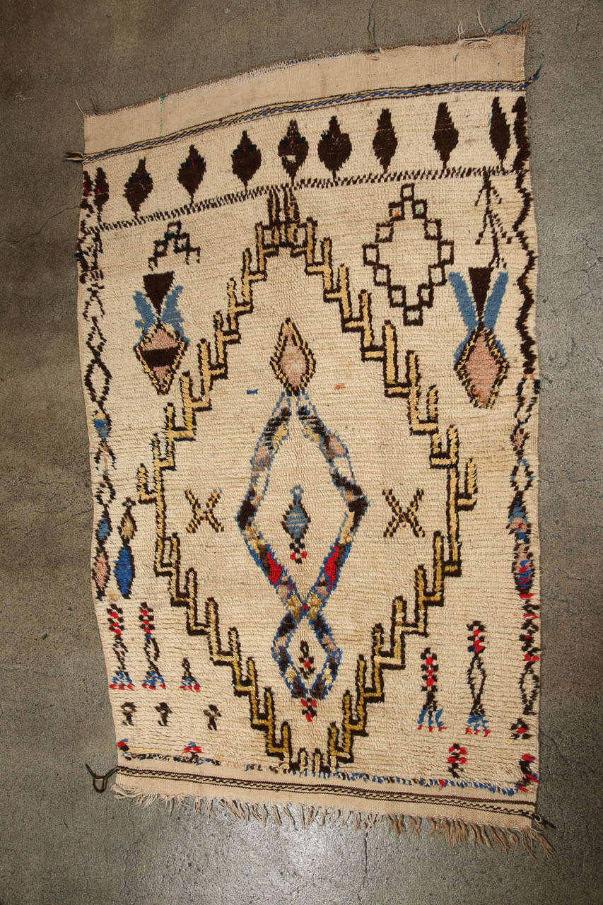 Wonderful example of Moroccan Berber weaving from the High Atlas region.  This Moroccan rug features contemporary abstract geometrical designs with shades of yellow, browns, red and turquoise woven in a naive tribal pattern on a creamy field.
Great