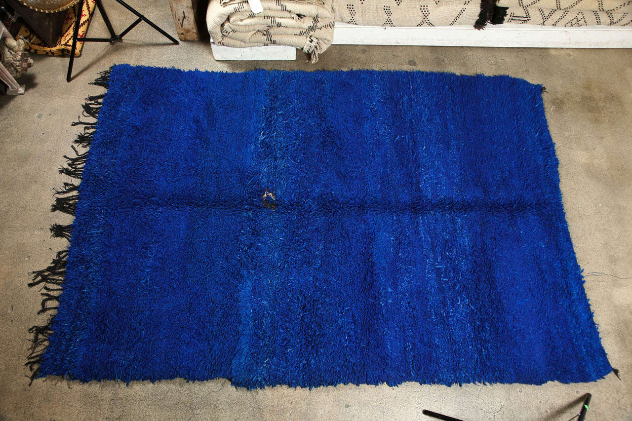 Gorgeous amazing Indigo blue shaggy long pile Moroccan tribal wool rug, handwoven in Morocco by the Berber women of the Beni Ouarain tribe.  
Rare to find this kind of deep indigo blue color in the Moroccan carpets.
All different shades of blue