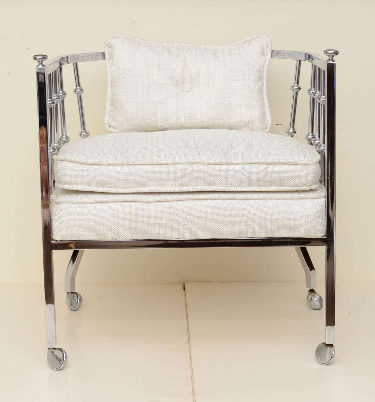 This unusual and newly upholstered and chrome side chair has wonderful period wheels. This is designed by James Peade for Drexel's Viewpoint 70 Collection. It is chrome over stainless steel. It has been newly upholstered with an off-white /white
