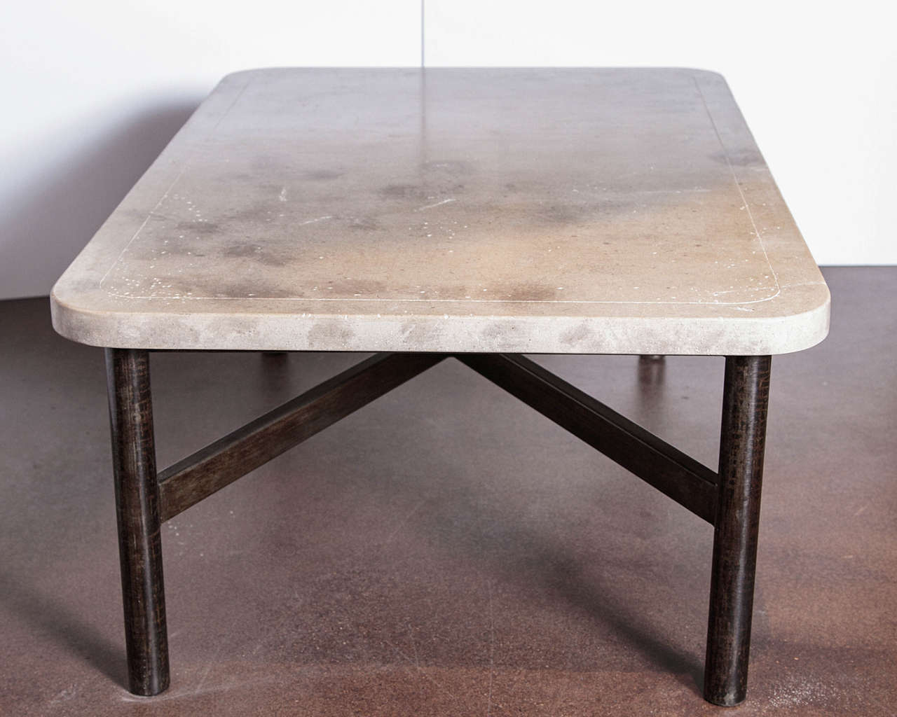 Transitional coffee table steel base with limestone top.