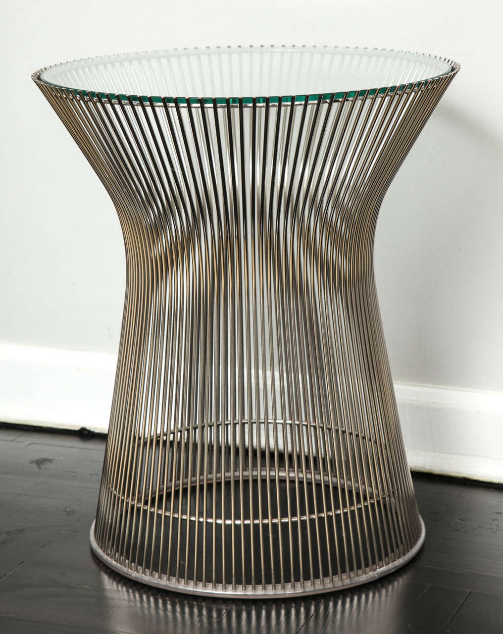Nickel table with glass inset top. Retaining original plastic floor guard. In excellent condition.