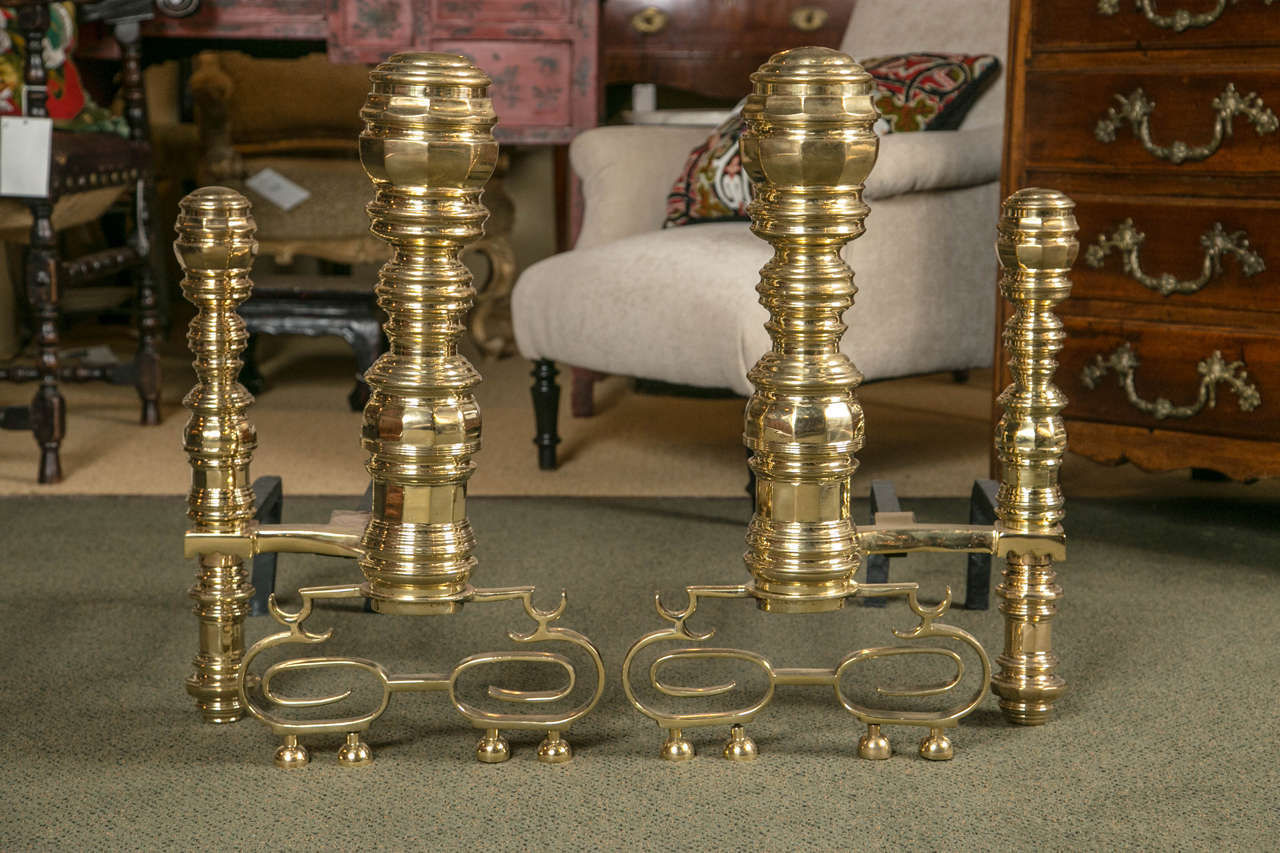 A monumental pair of double beehive brass andirons.