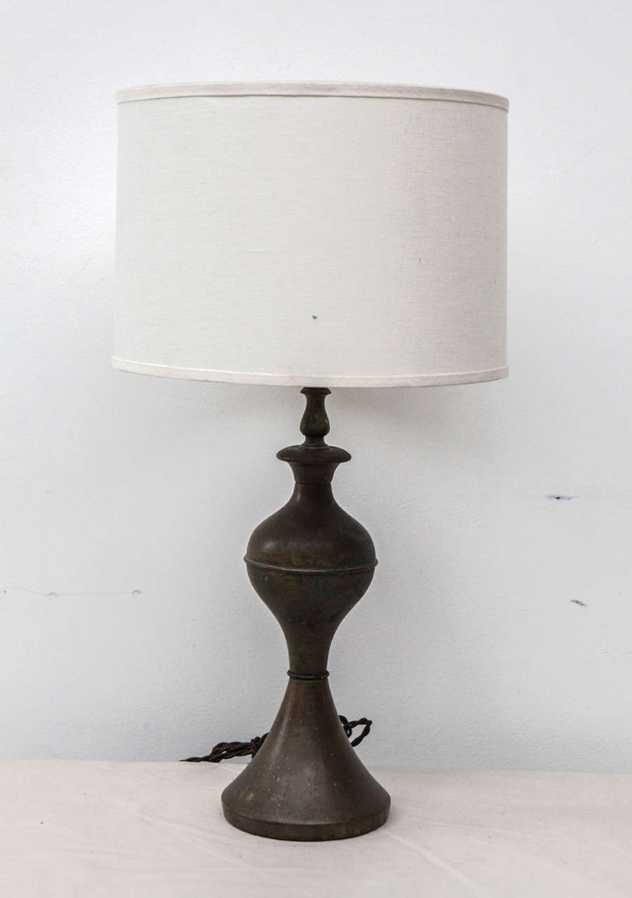 Charming small table lamp in brass hourglass silhouette with healthy patina finish. 6
