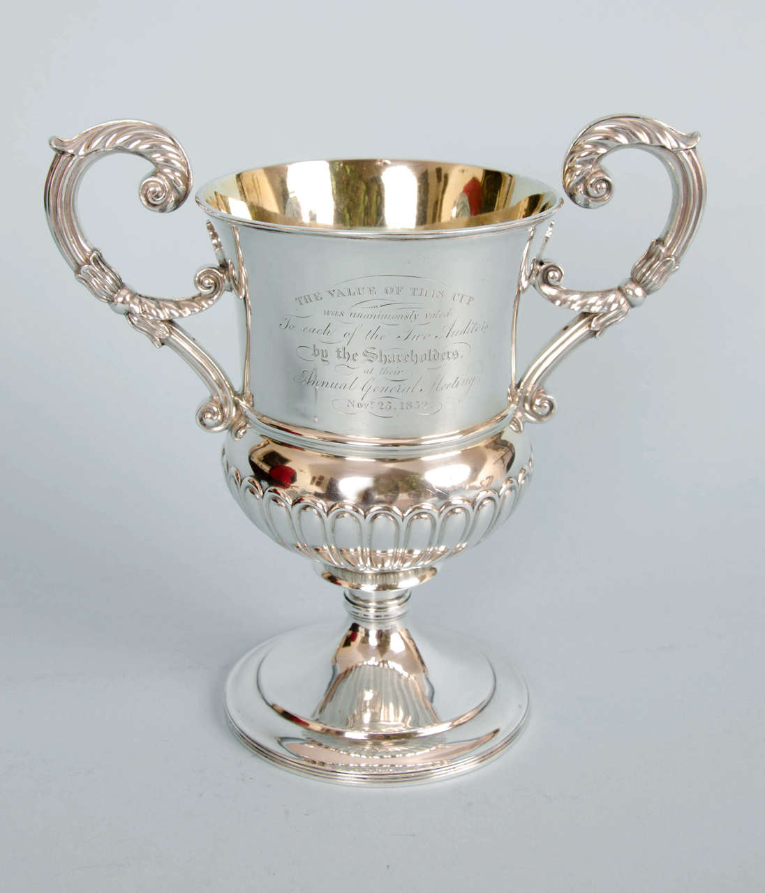 Beautiful engraving on a George III two-handled, thistle form sterling silver presentation cup of extremely good gauge. 
Hallmarked Edinburgh 1816 but presented in 1852. The hallmarks are stamped below the rim of one side of the cup and also