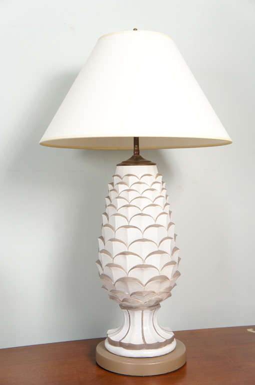 Glass white and lamp gold pineapple lamp. Gold details outline each leaf.
Mounted on gold tone metal base. Shade not included.