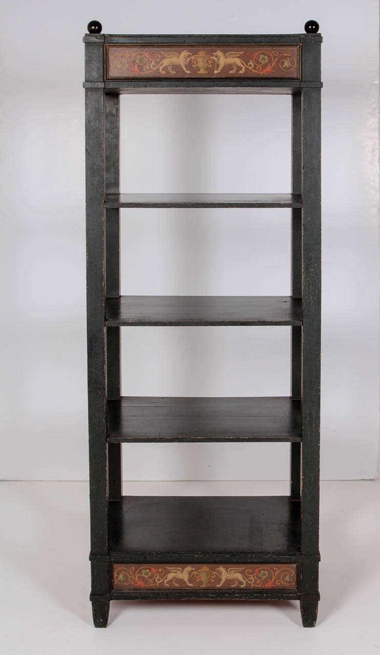 A Danish painted etagere, Circa 1850's, of rectangular form with four shelves raised on square supports surmounted with ebonized ball finials, with a Classically painted upper and lower frieze.

Original paint. This etagere is painted in the
