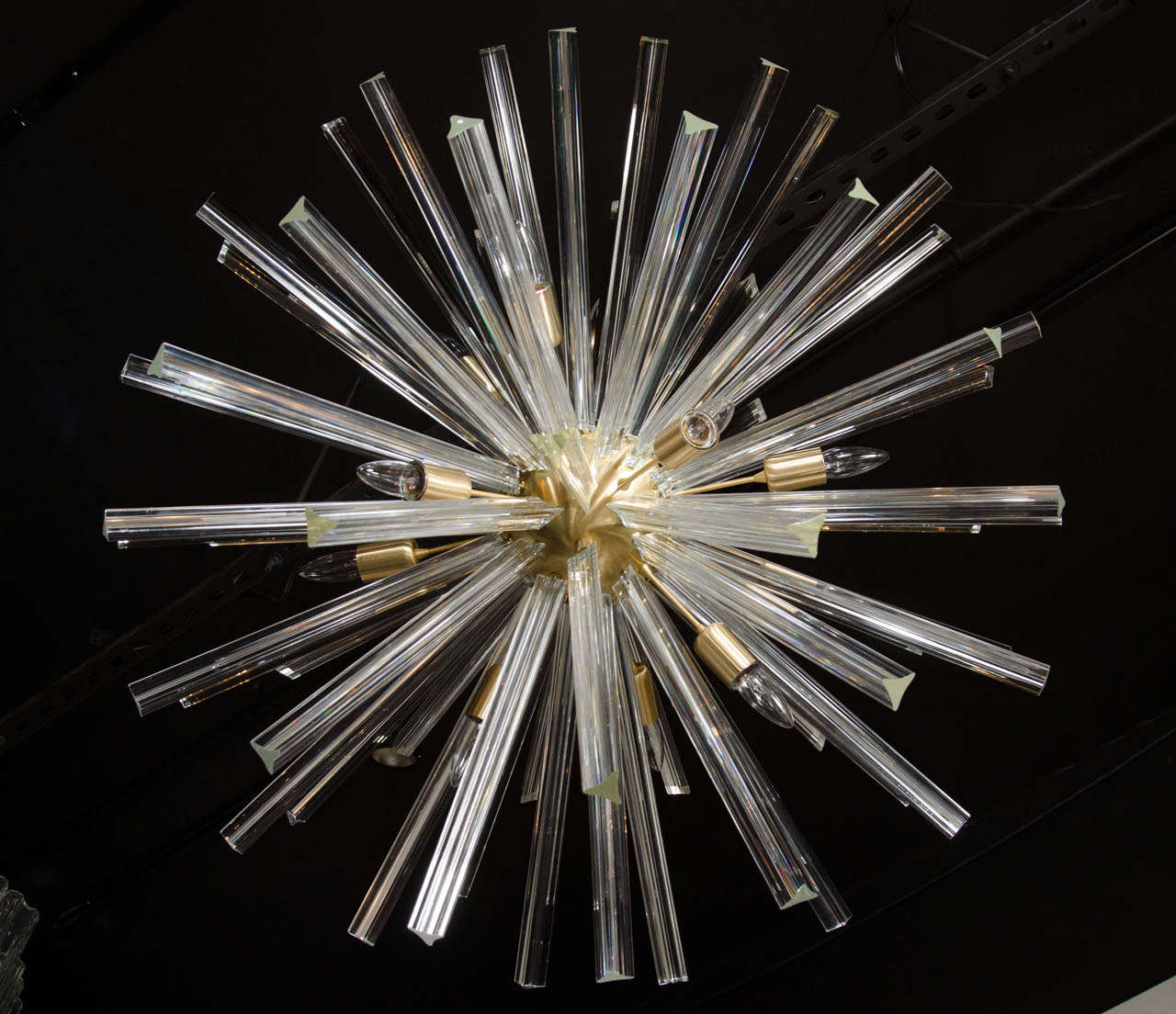 This spectacular chandelier consists of a series of Murano Glass Triedre shaped crystal rods extending from a brushed brass centre sphere. It accommodates twelve chandelier bulbs and has been newly rewired to American standards, the overall hanging
