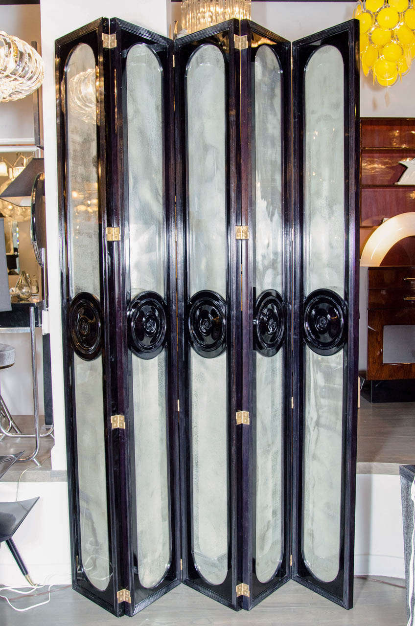 This Art Deco Mirrored Screen features five panels of ebonized walnut with antiqued mirror inserts. This screen is exceptional, it's tall and narrow panels will help to give the illusion of height to an otherwise height restricted space. Mirrored