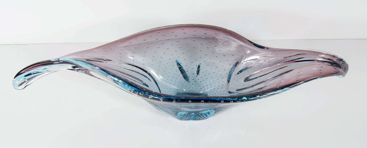 This stunning bowl features a great organic free form design in colors of cerulean blue and plum. It also has murices throughout as well. Great  used as a centerpiece or on a console.