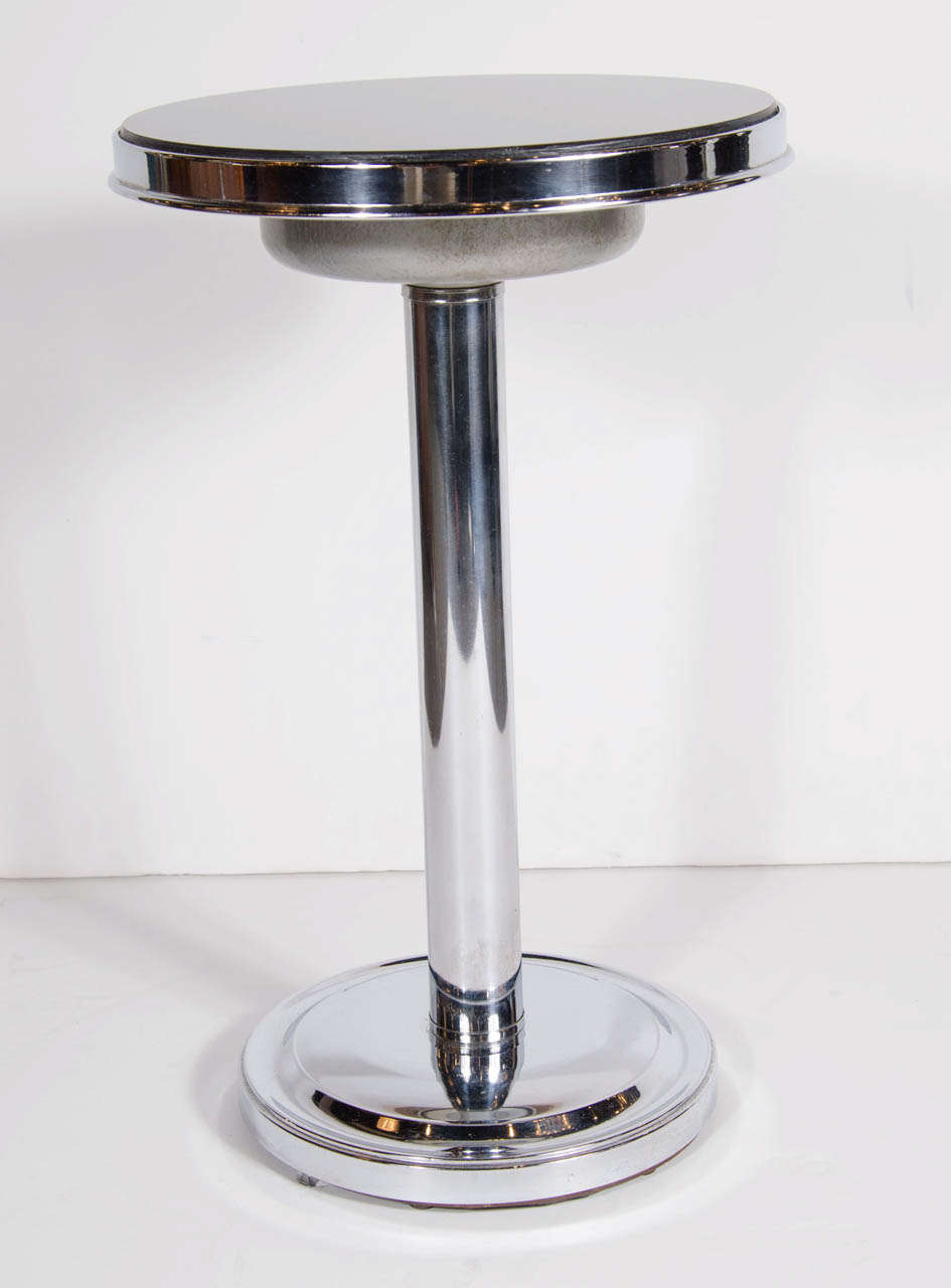This stunning table features a vitrolite top and a chrome pedestal base .A great example of the Machine Ages influence on Art Deco in America. This table is in mint condition.