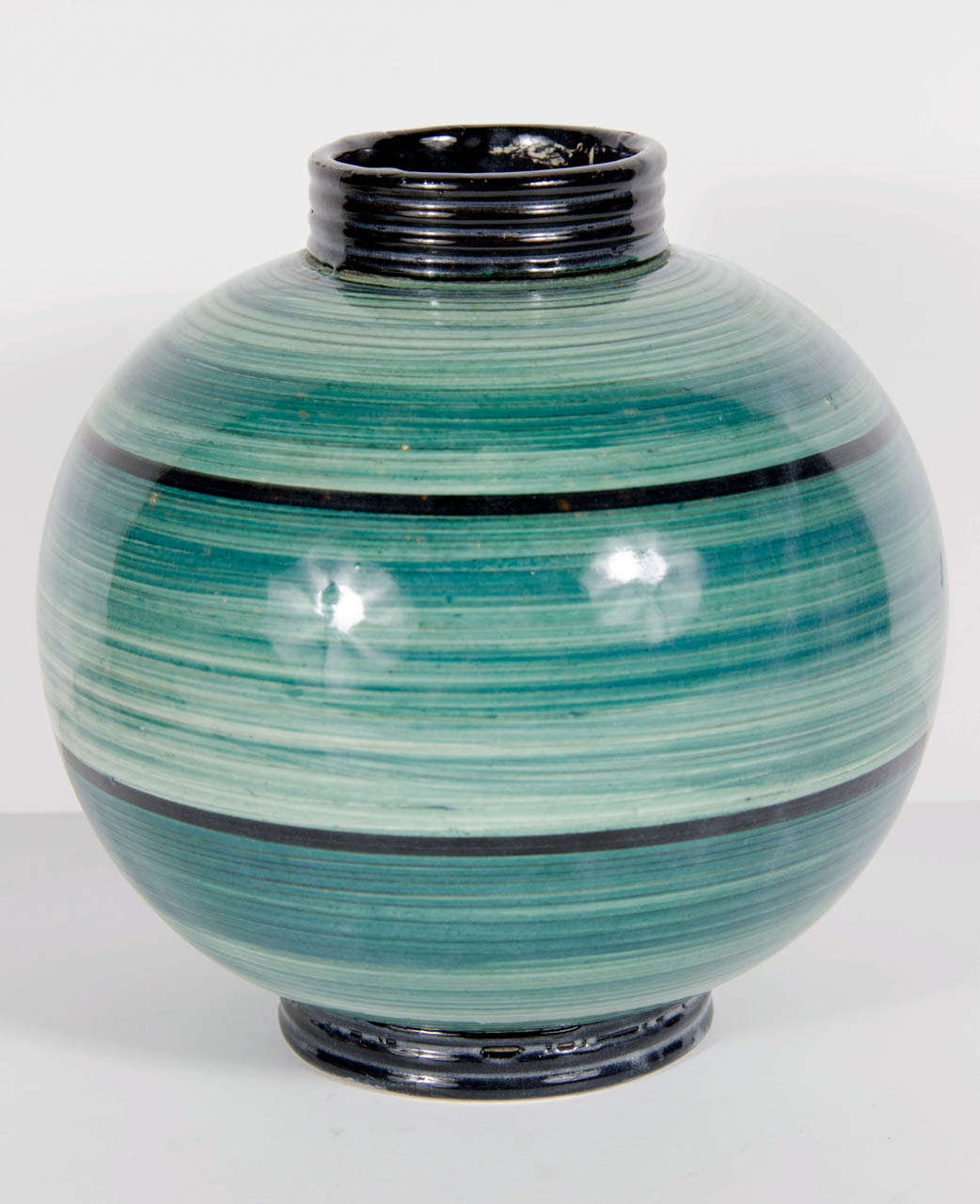 This exquisite vase by Ilse Claussen of Sweden has a large round bulbous form and small tapered top and base. In aqua blue green glaze with stylized hand painted brushed Art Deco linear detailing.  Signed on the bottom with Ilse Claussens initials