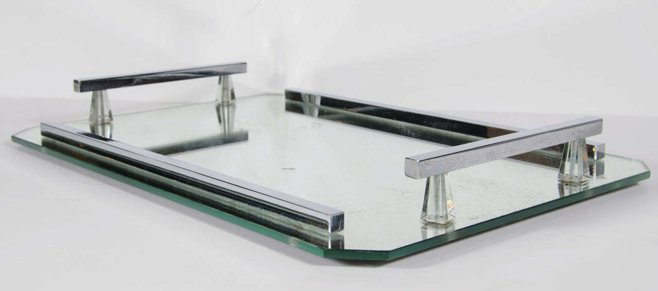 This gorgeous and Elegant tray features an antique mirror tray with chromed railings fitted with cut crystal spacers. The tray has a slight hexagonal form.