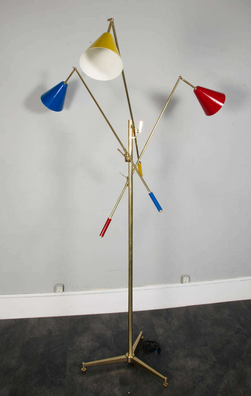 Italian floor lamp in brass. 
Three lights.
In the manner of famous Angelo Lelli Triennale.
Italy 1970