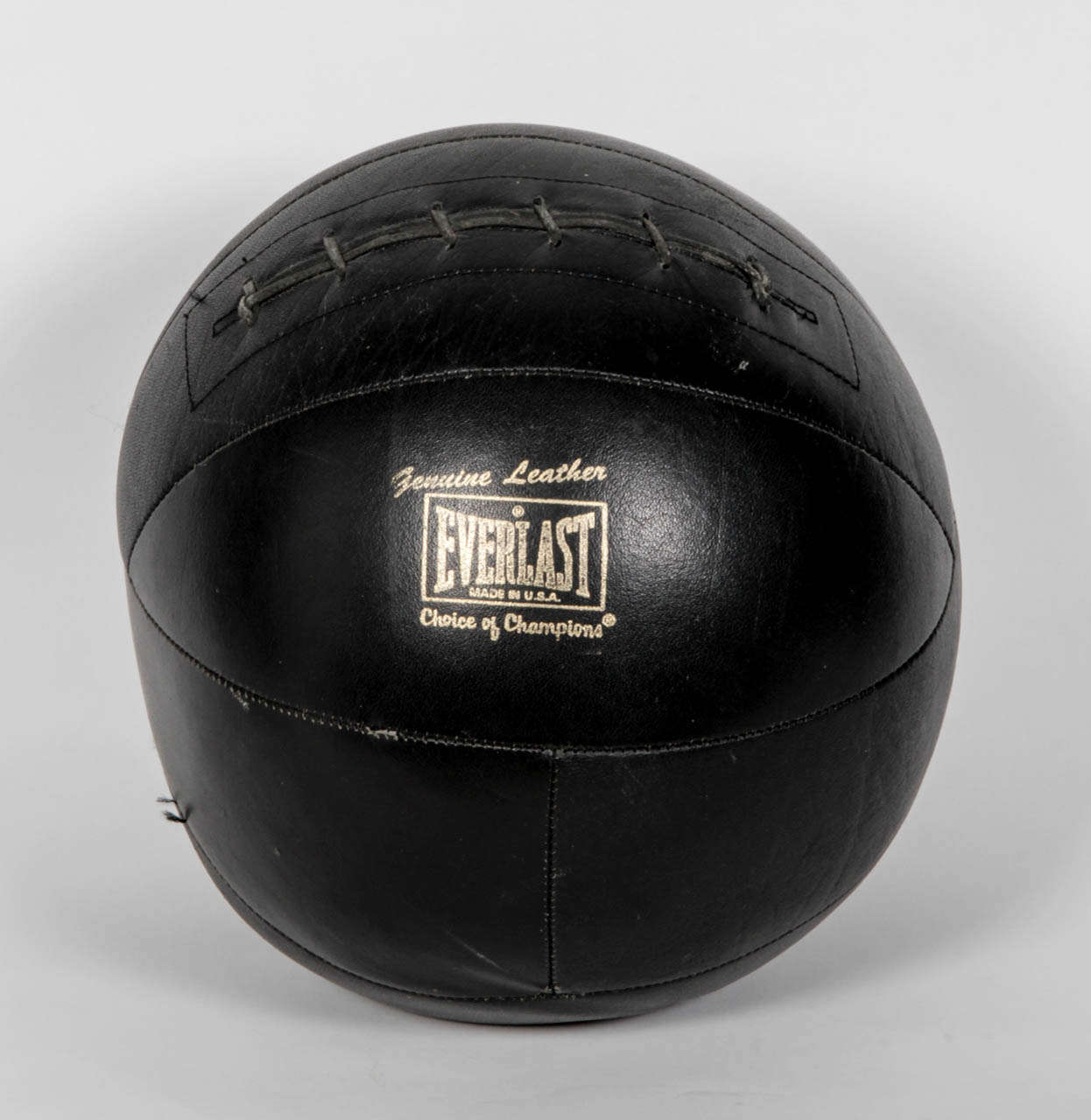 Black leather medicine ball by Everlast.  USA, circa 1950, possibly earlier.  Signed in gold lettering.  Original black lacing.