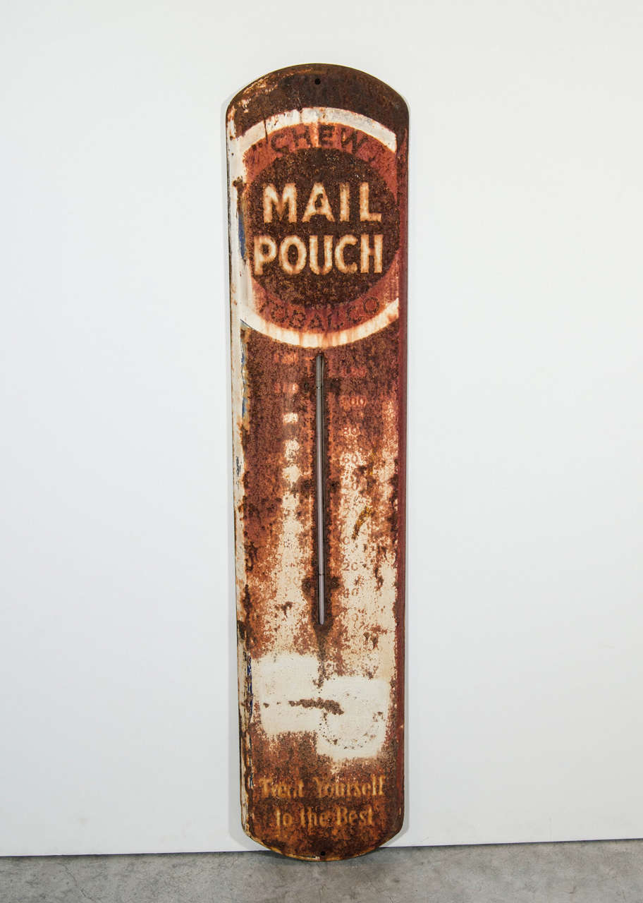 A rugged, weathered Mail Pouch chewing tobacco thermometer advertising sign.  Bearing the logo 