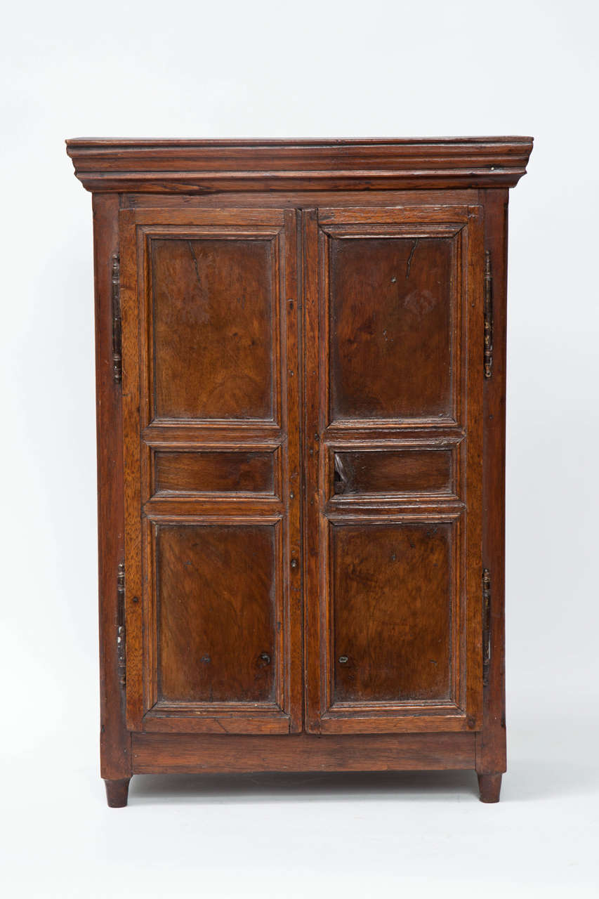 A splendid example of miniature work, this French Provincial is a beautifully made example of the cabinetmakers small-scale work at its best. Of particular note are the triple panelled doors.

19th century.