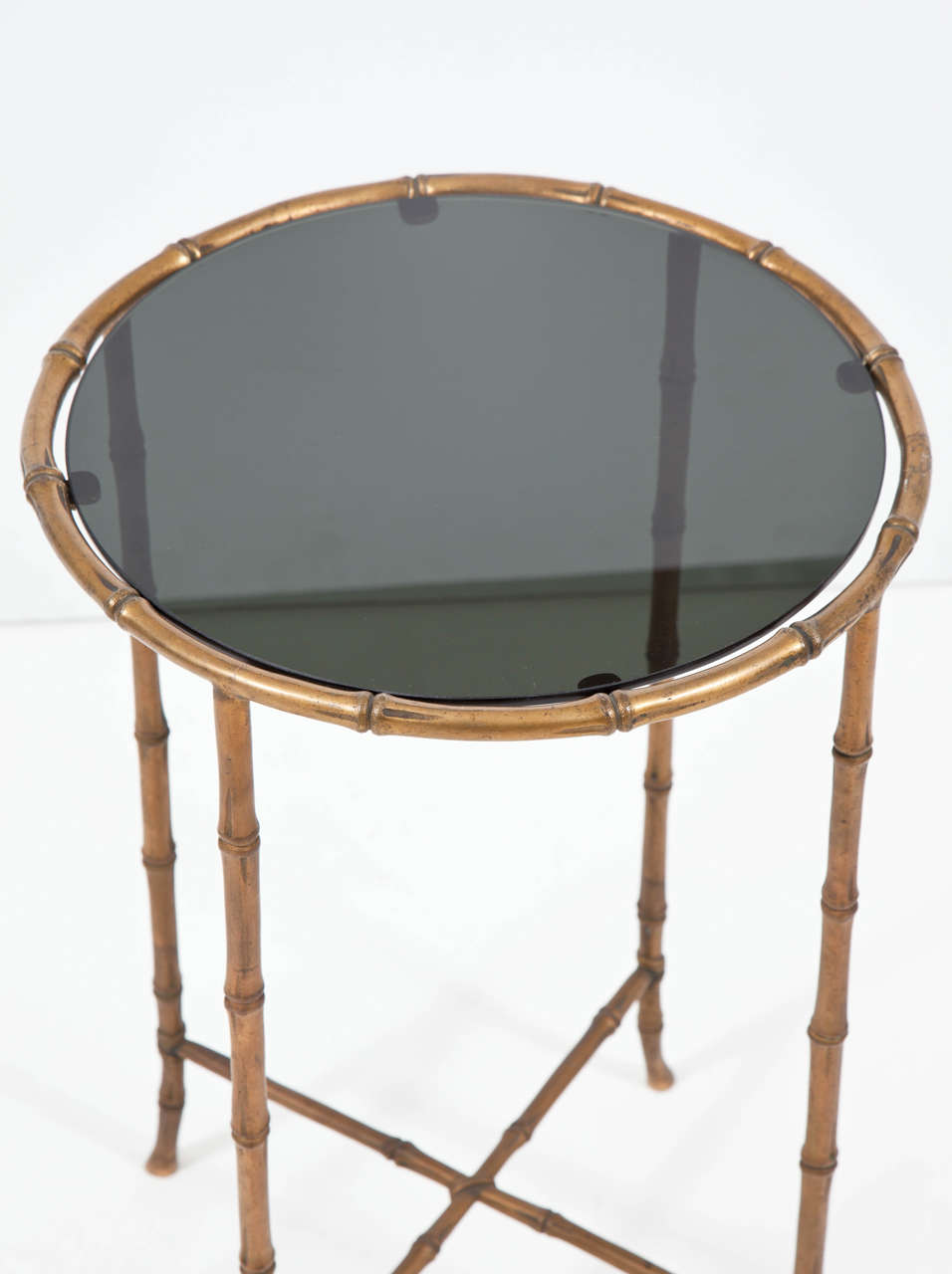 Bronze faux bamboo side table having inset black glass top