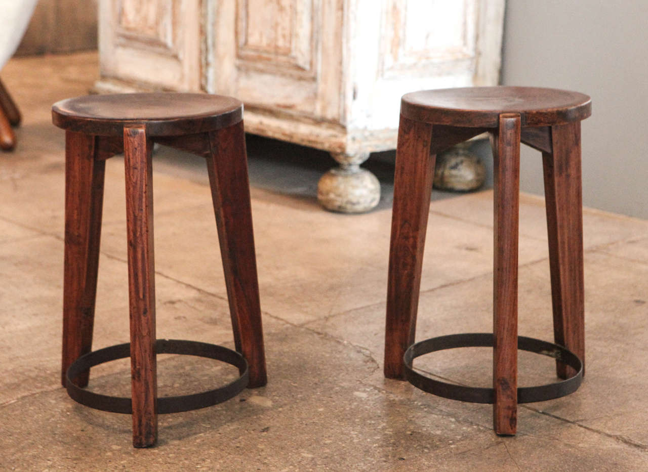 A pair of teak stools designed by Pierre Jeanneret for Punjab University in Chandigarh, India.
