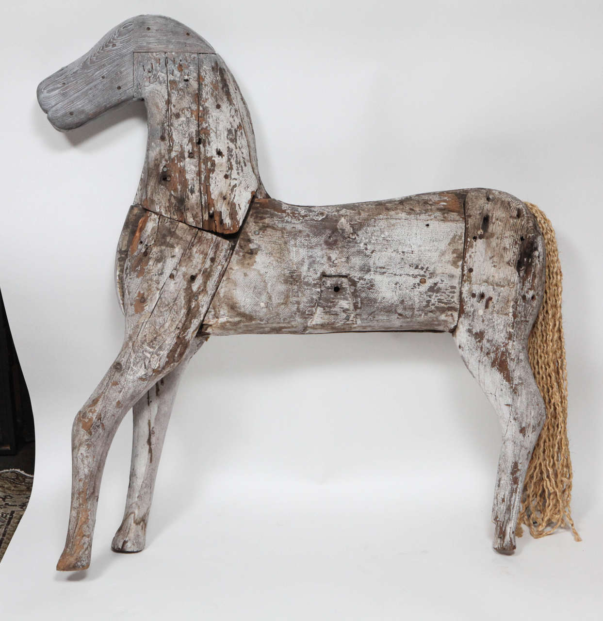 Hand-carved 19th Century wooden rocking horse with original rope tail.