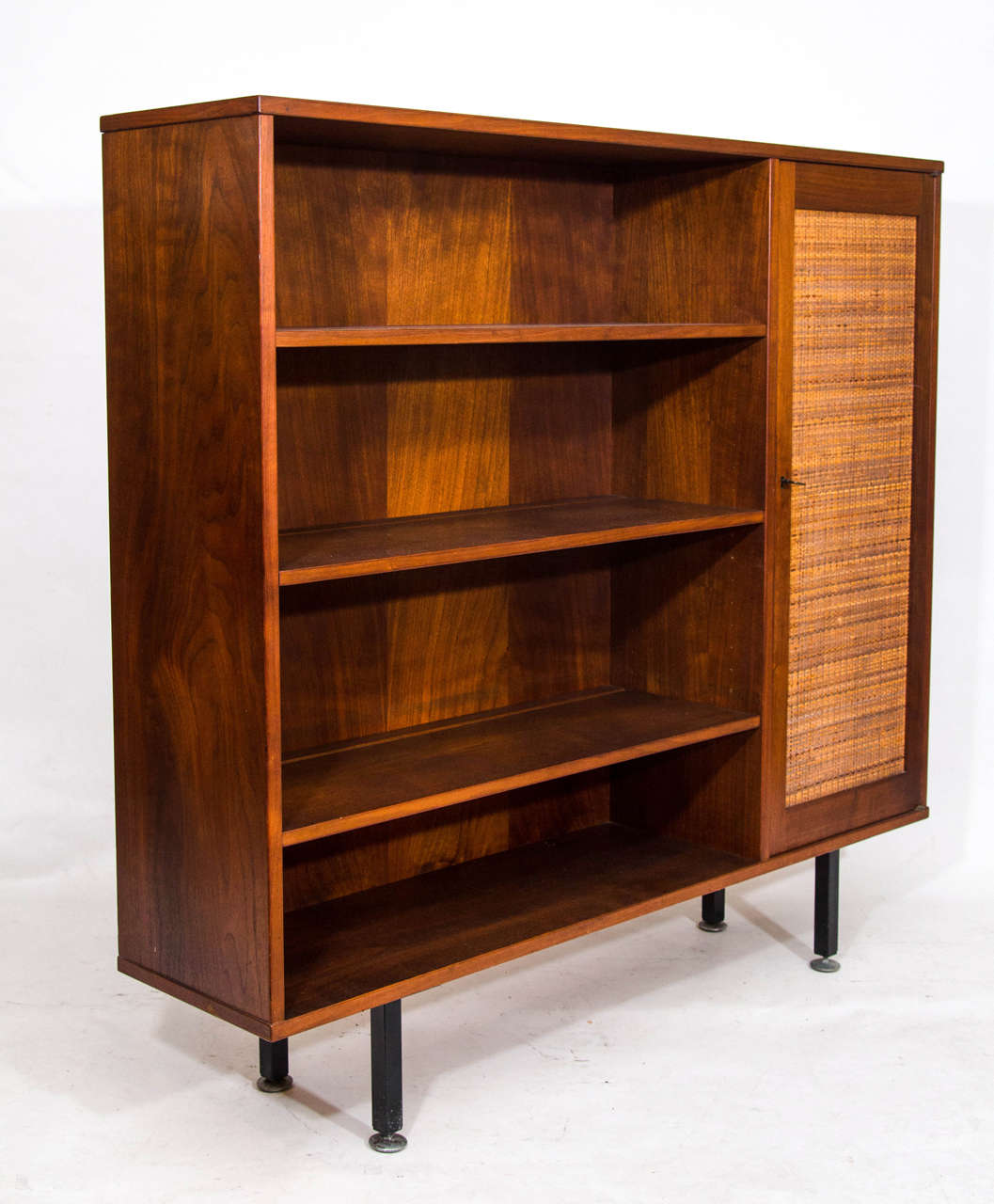 Handsome and compact bookcase with closed cabinet on black metal legs. Please contact for location. Offered by Las Venus by Kenneth Clark, New York City.