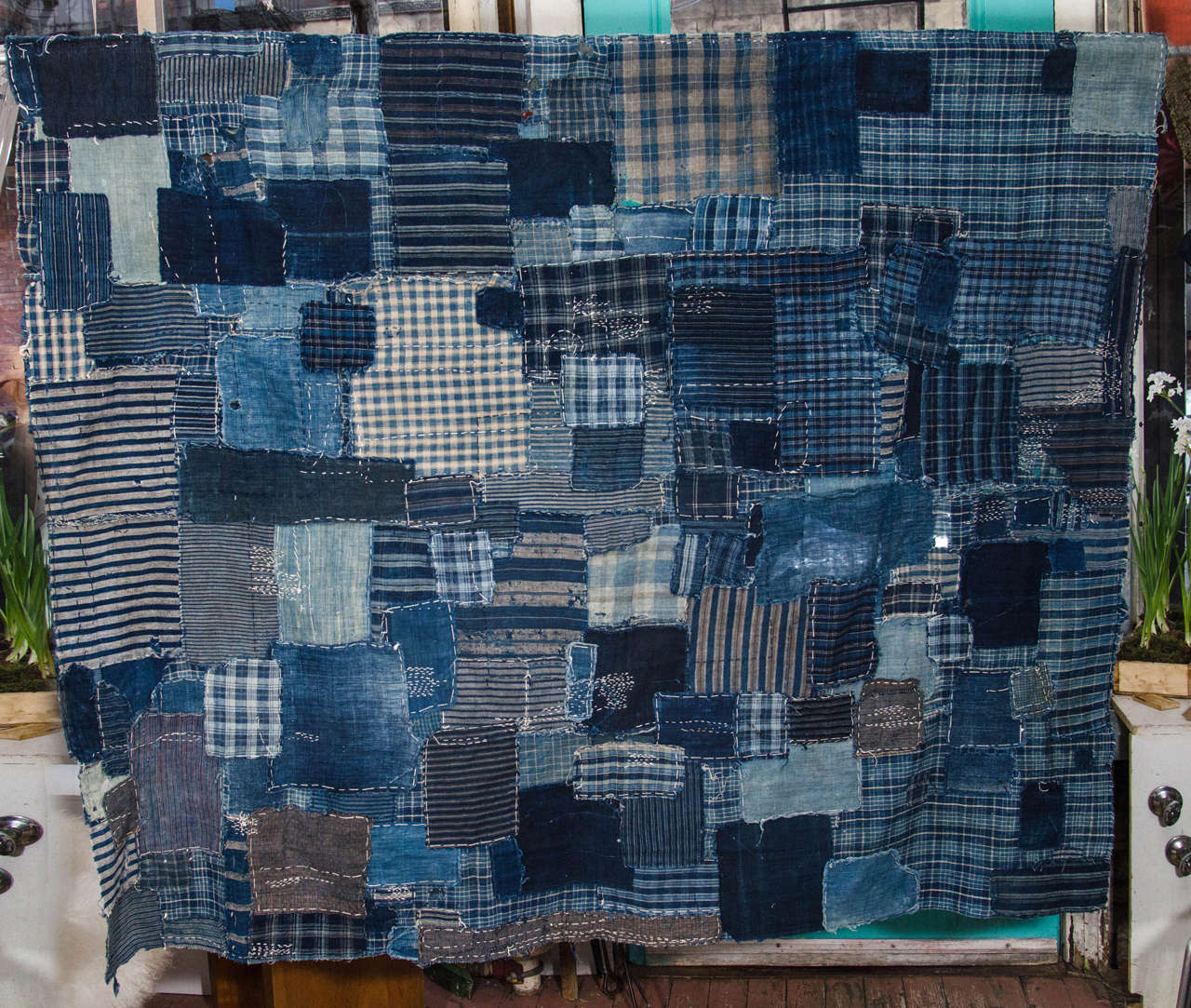 Japanese Edo period Boro. Patchwork hand-sewn indigo dyed fabric made from 19th century Japanese hand loomed futon fabric, with heavy repair.
View.