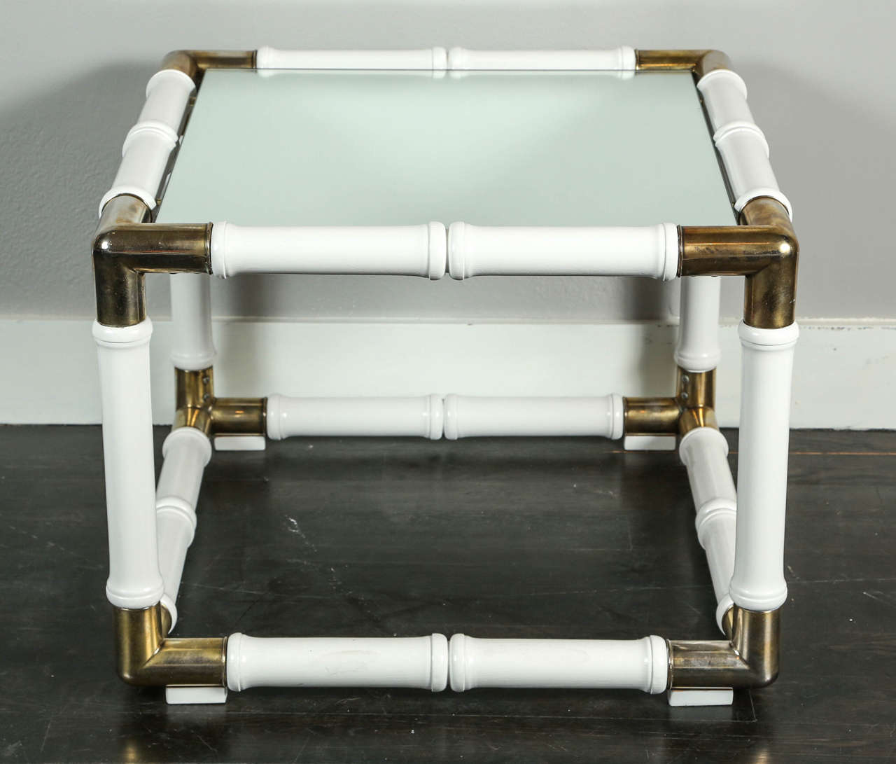 Pair of unique bamboo style coffee tables Hollywood Regency. Wood handmade lacquered in white, with brass corners and mirror top.