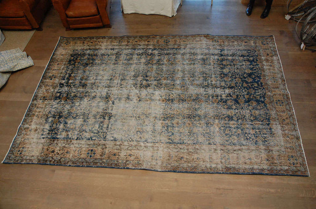 Beautifully aged Anatoly rug in faded blues and camel.