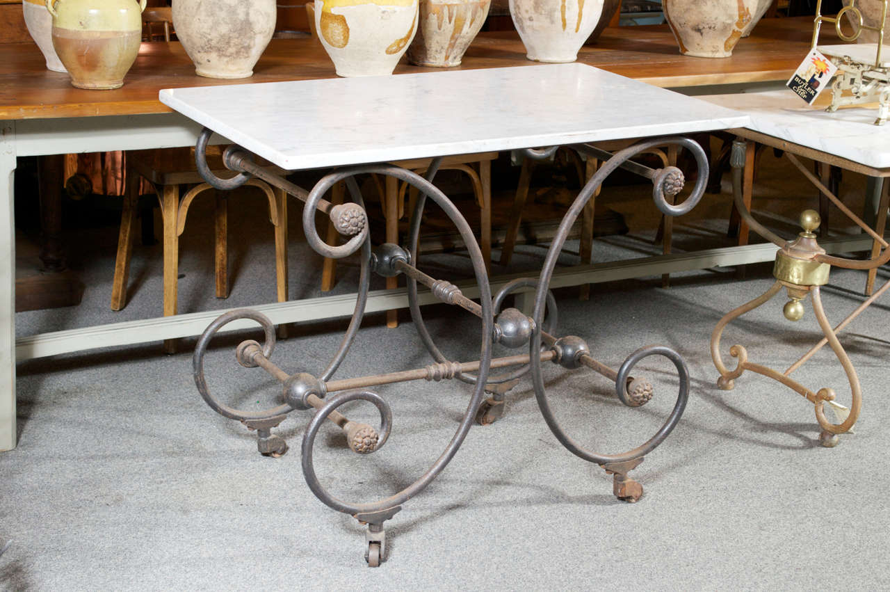 White marble top butcher/pastry table on an elegant cast iron base with castors.   Very good working height.