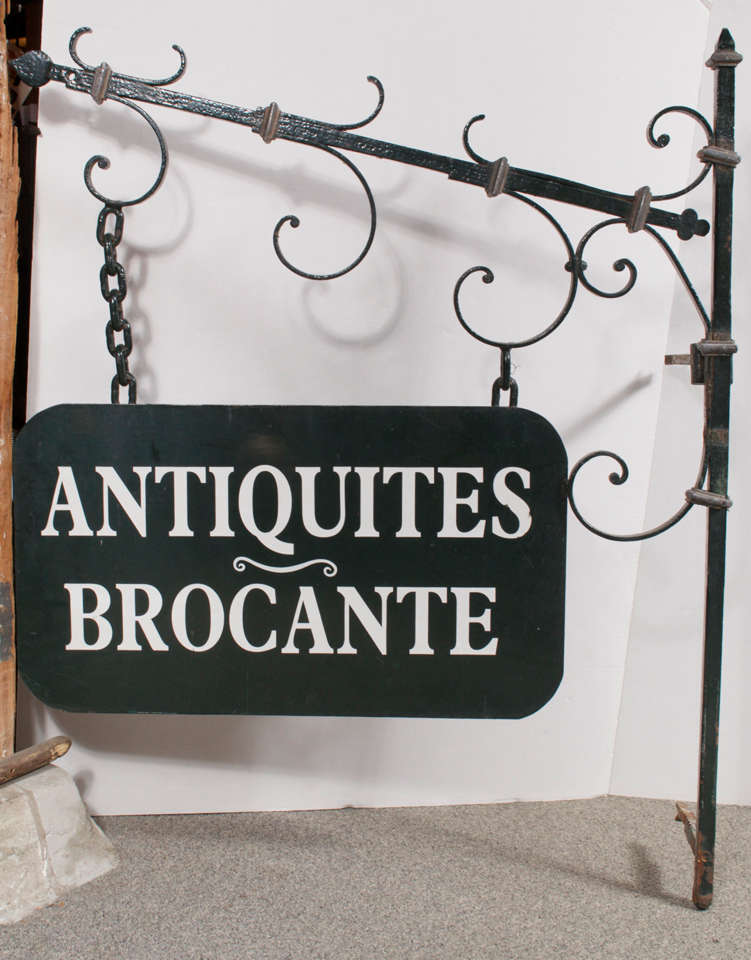 Decorative double sided dark green painted forged iron 'ANTIQUITES BROCANTE'  shop sign