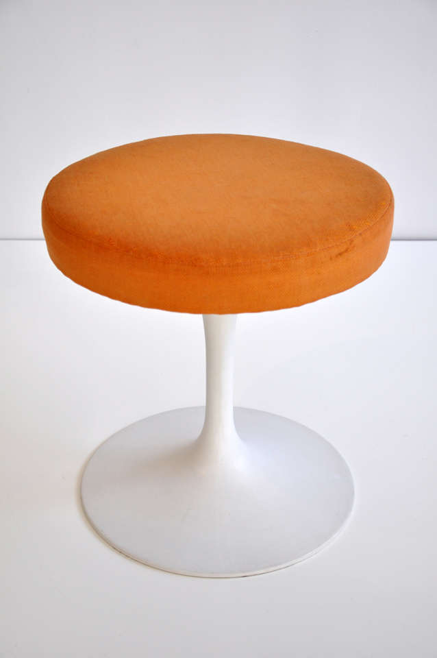 Mid-century tulip stool designed by Eero Saarinen (1910-1961) for Knoll.  Original fabric, felt floor protector on base  and early Knoll Associates label. By creating the 
