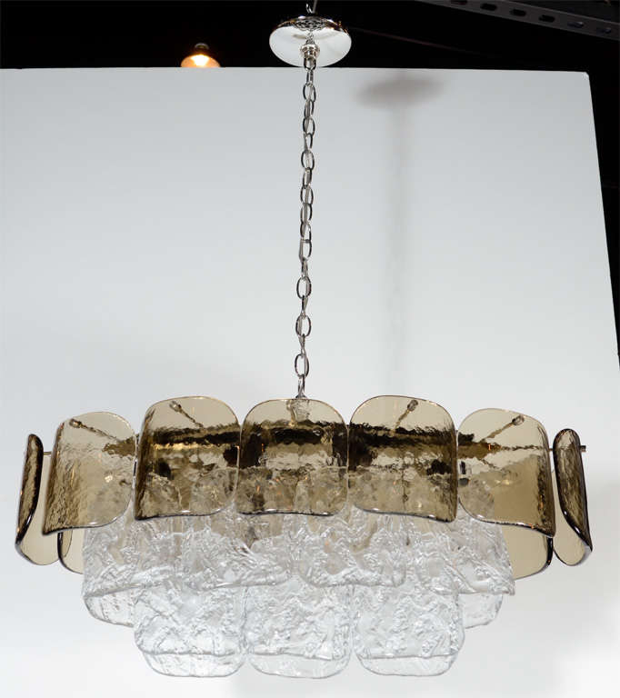 This gorgeous chandelier features three tiers of textured and hand blown Clear  Venini glass  with the top tier in smoked textured glass. This chandelier has been completely rewired and can be adjusted to any height and is fitted for 6 lights.