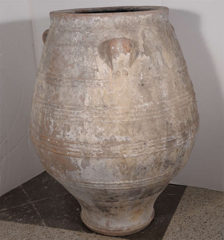 Large Greek olive storage jar in terra cotta with traces of lime.
Additional olive jars available on request.