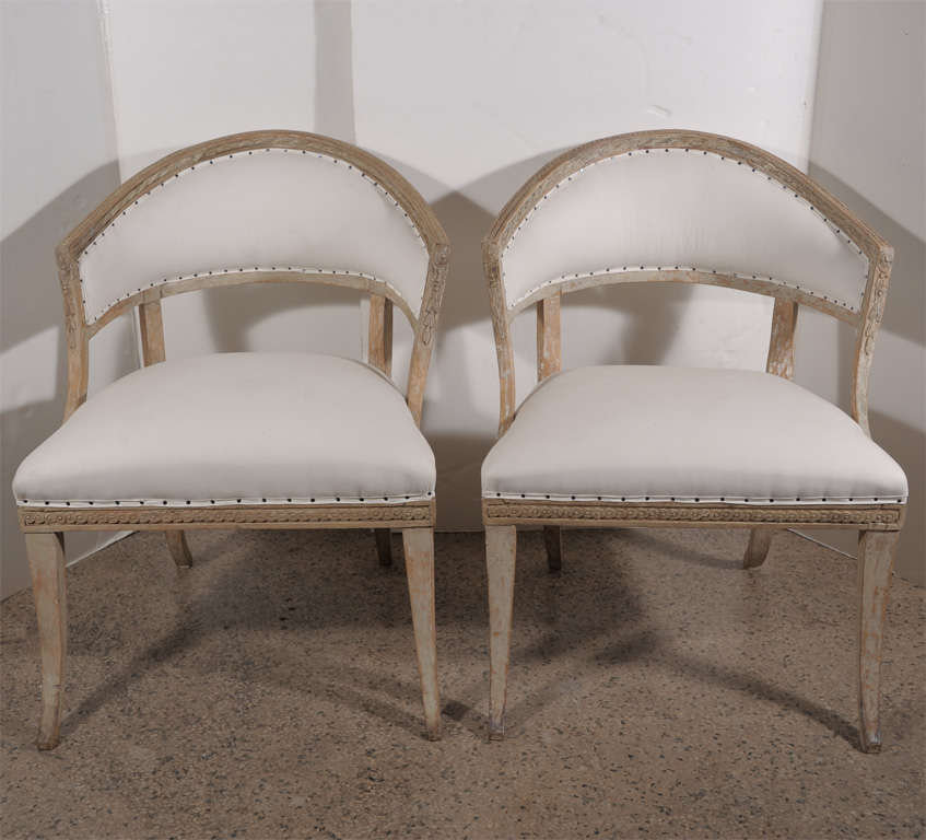 Pair Swedish barrel back chairs with applied Empire motifs and saber legs. Scraped to original paint. Chairs have been reupholstered in white ticking.
Circa 1805-1815