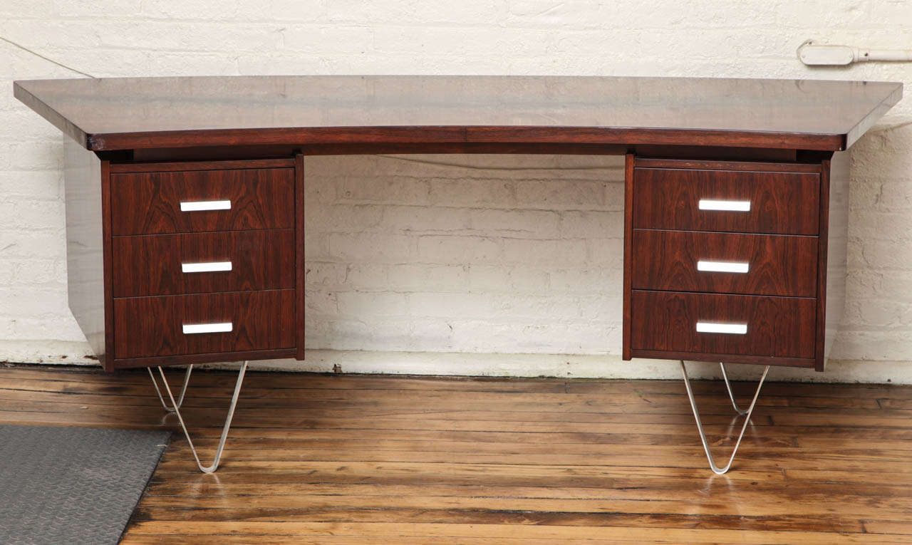 A Mid-Century Modern desk in walnut with brushed chrome base and drawer pulls. Cees Braakman design for Pastoe, Holland. The 