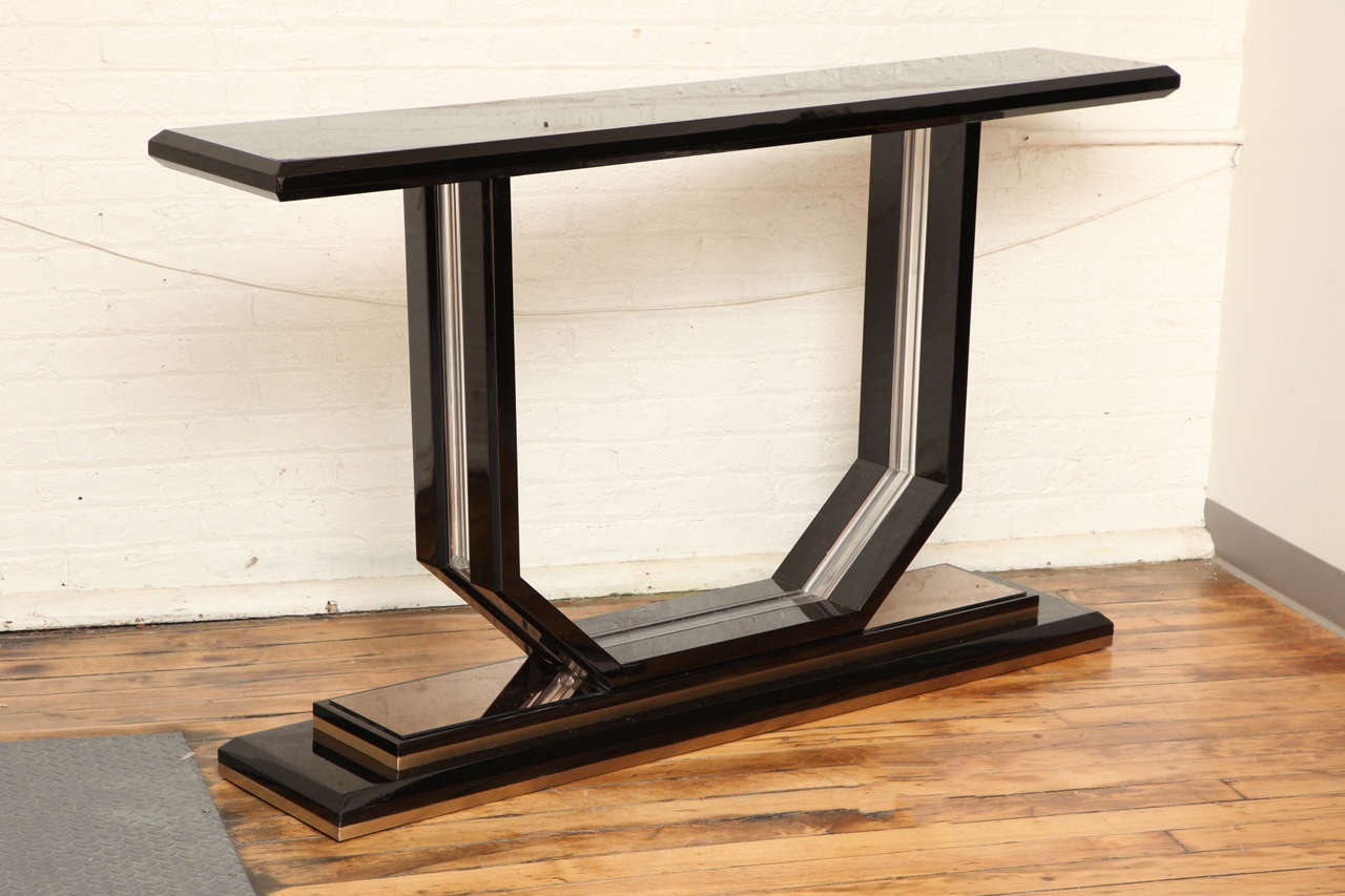 Chic modernist console table . Plexi and black lacquer wood with nickel trim.