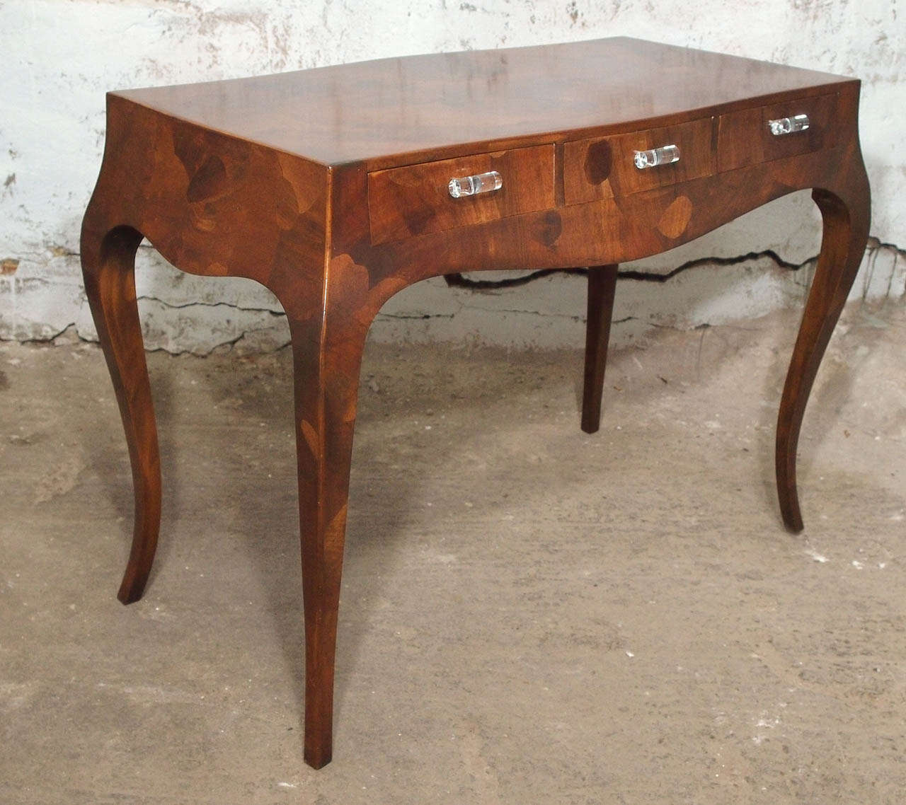 This is a sleek piece. A Mid-Century Modern Italian writing desk in a unique wood veneer which consists of various collections or patches of different types of woods including Italian olive tree wood. This piece was completely restored and