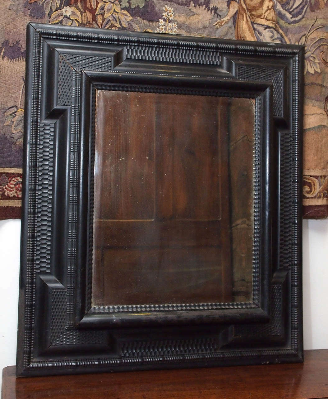17th century Dutch ebonized frame with hand layed and beveled glass mirror.