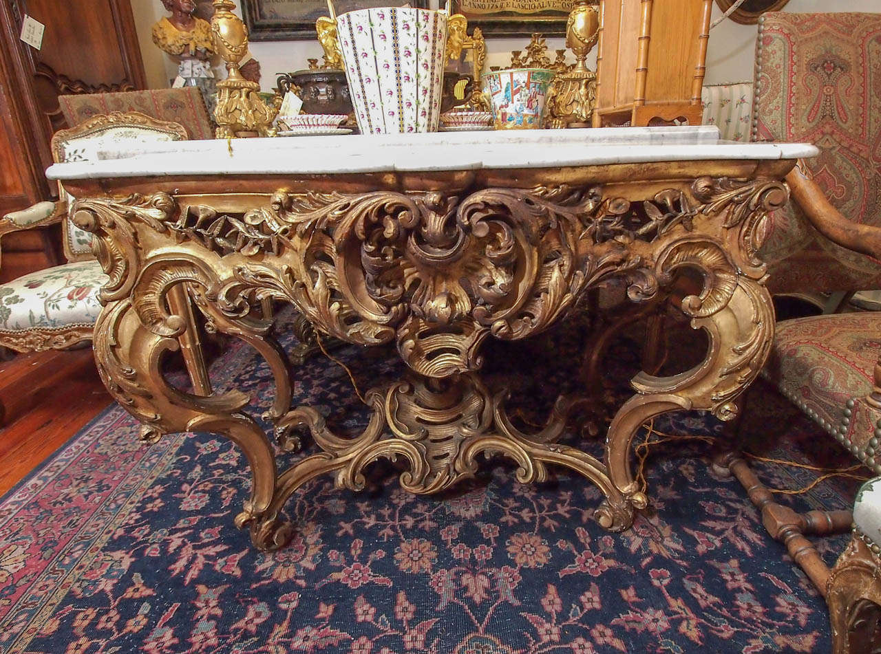 French Louis XV Freestanding Console table with white marble top. has original gilt finish with expected chips and cracks