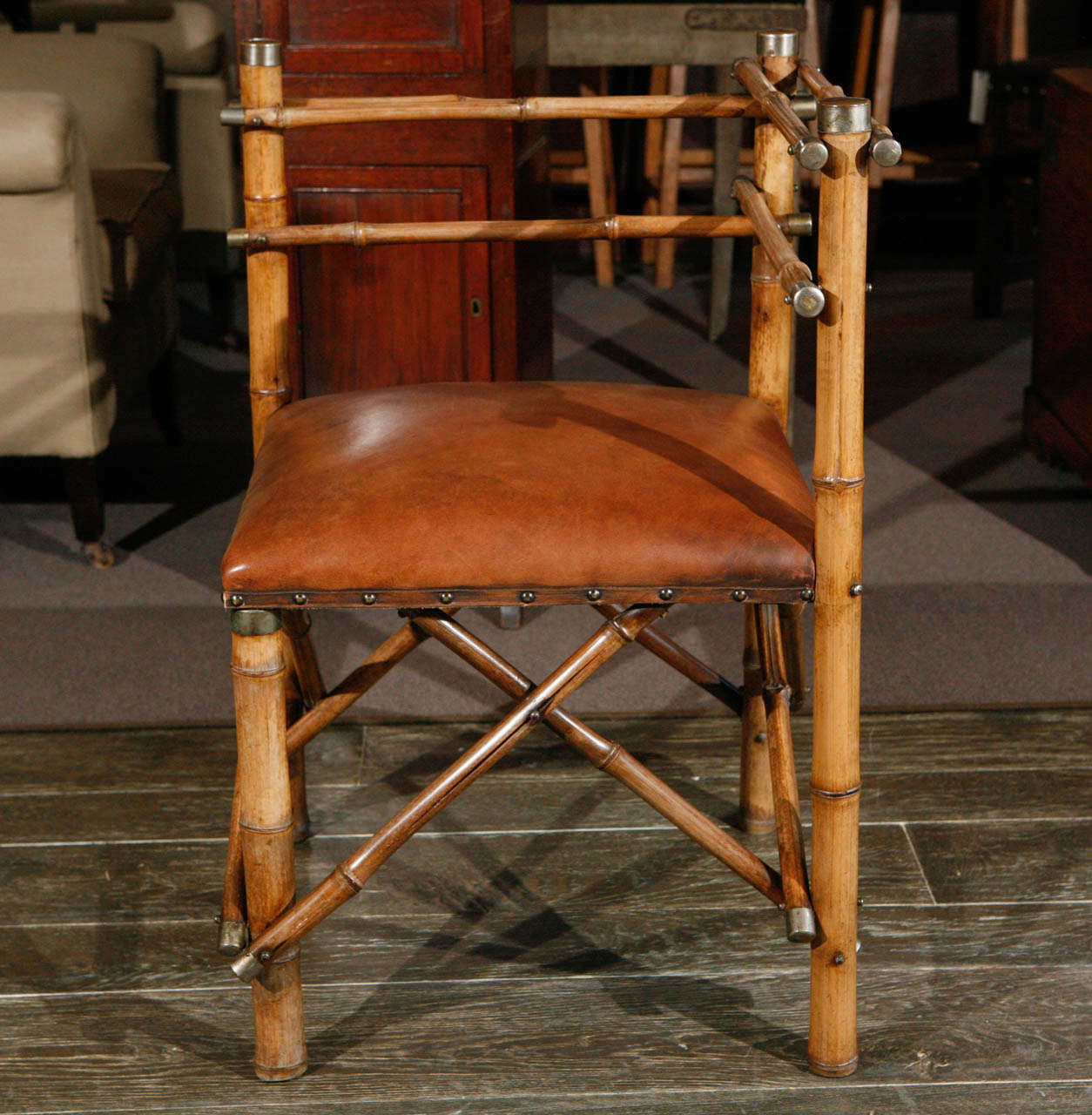 A corner chair in bamboo with a leather seat.