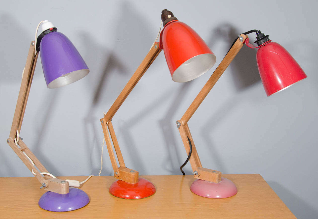 Vintage lamps with wood stems and plastic shades.
Available in purple, white or red. Lamps are priced individually.