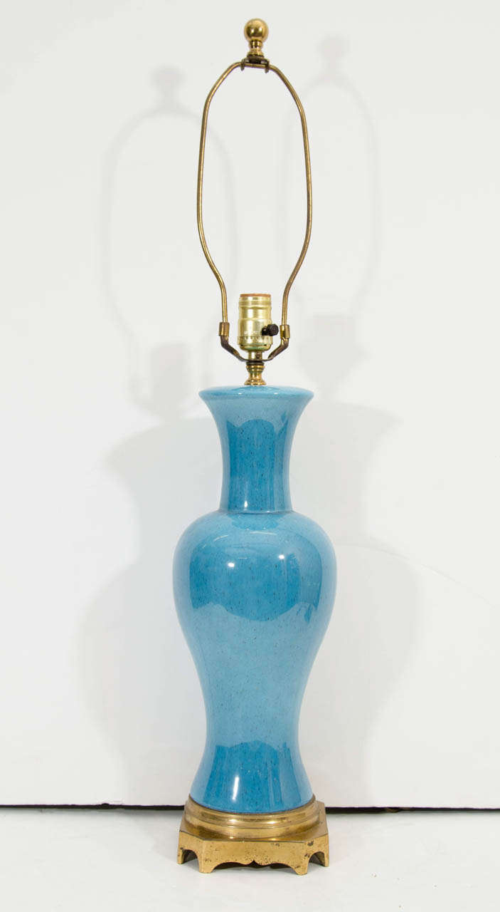 A vintage pair of Paul Hanson ceramic table lamps in turquoise blue on a brass base.