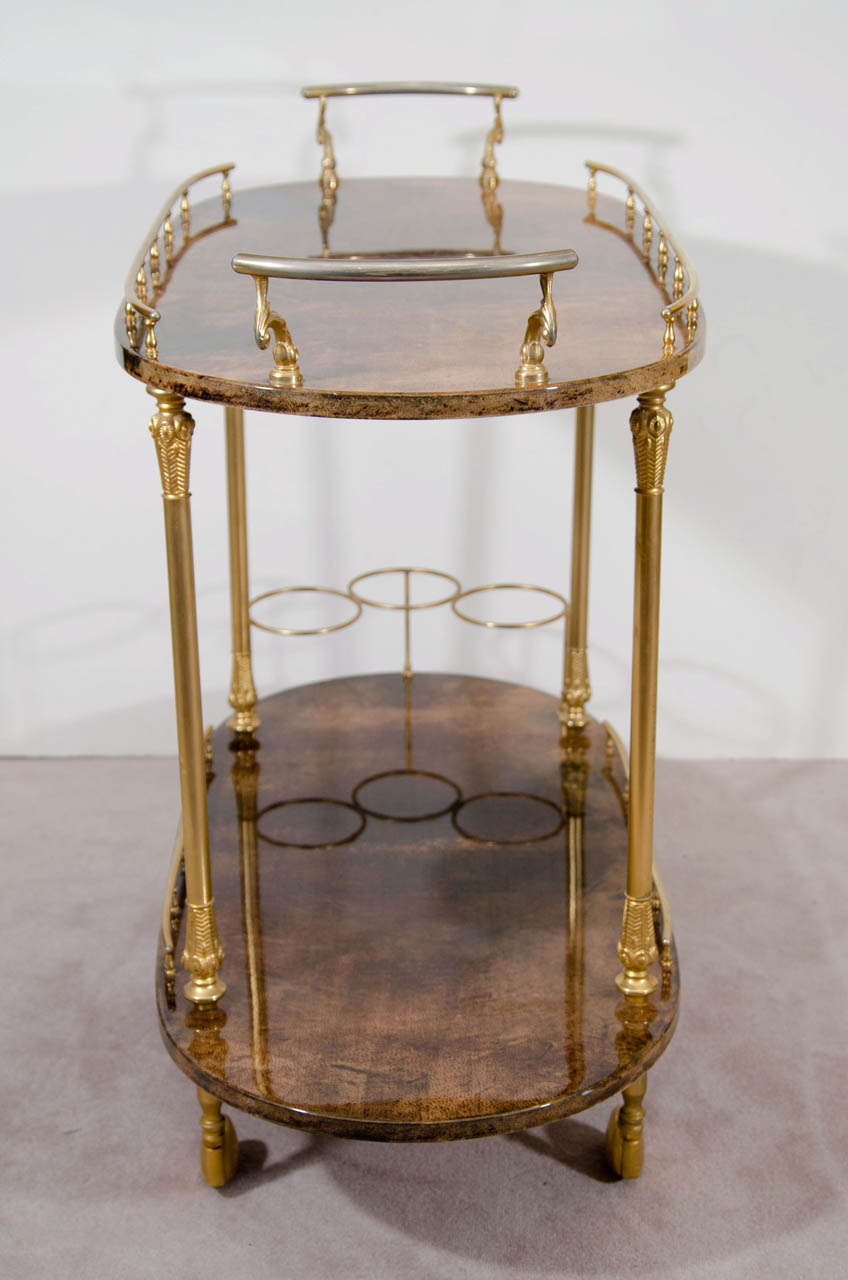 A vintage Aldo Tura brown lacquered goat skin two-tier bar cart with brass.  Age appropriate wear with some scratching and a small chip.
