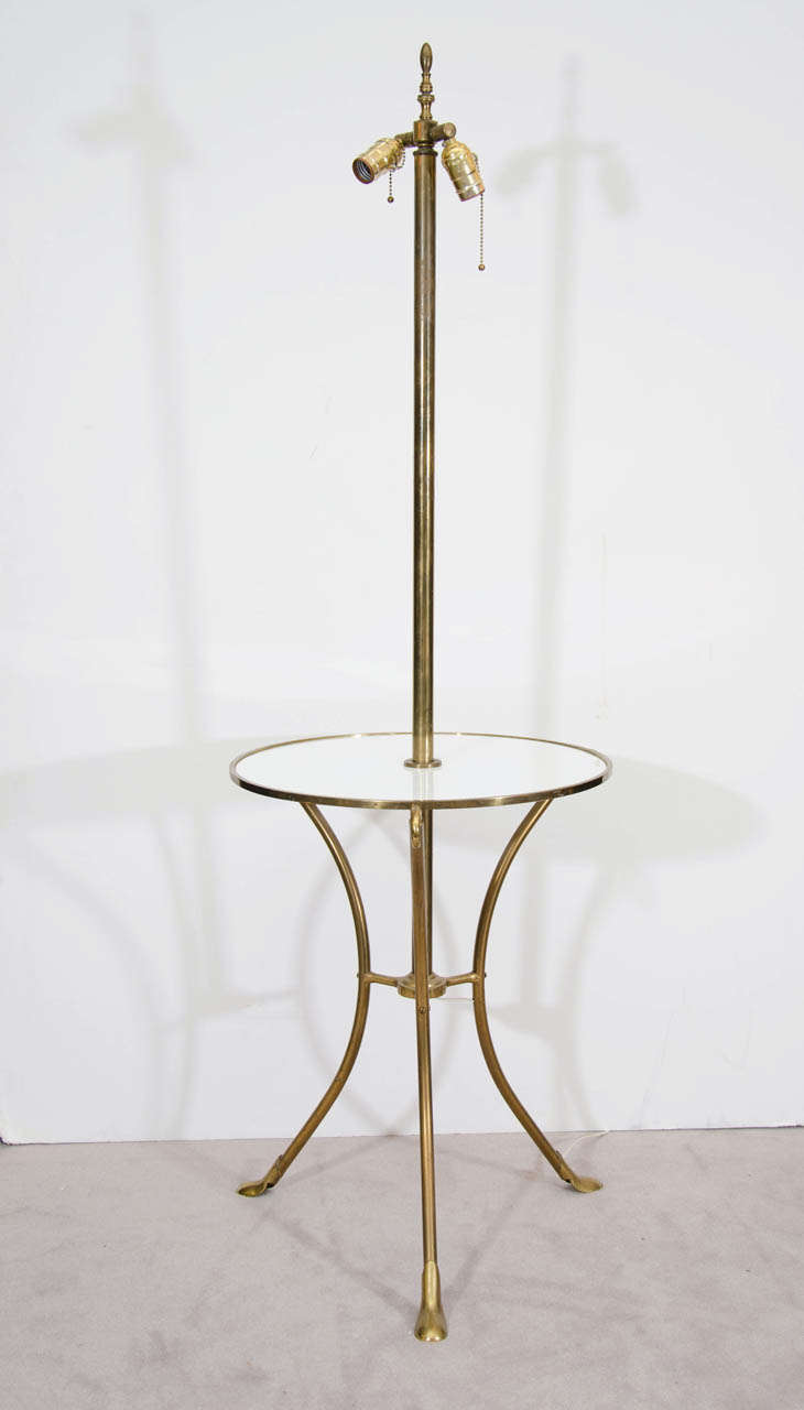 A vintage brass floor lamp with white glass table.  Age appropriate wear with some chips to the glass.