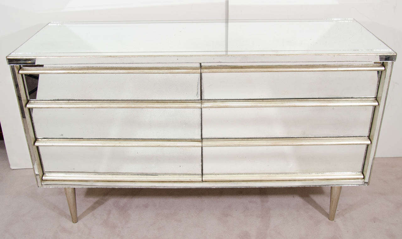 A vintage 6-drawer dresser with wood legs and an 