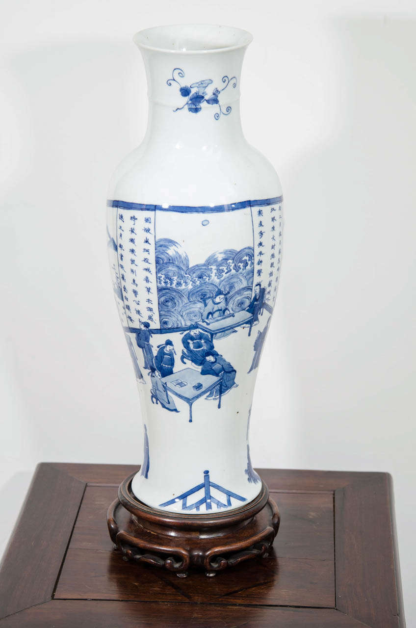 An antique 19th century large Chinese porcelain sleeve shaped vase. The piece is hand painted in underglaze cobalt blue with a continuous scene of a 