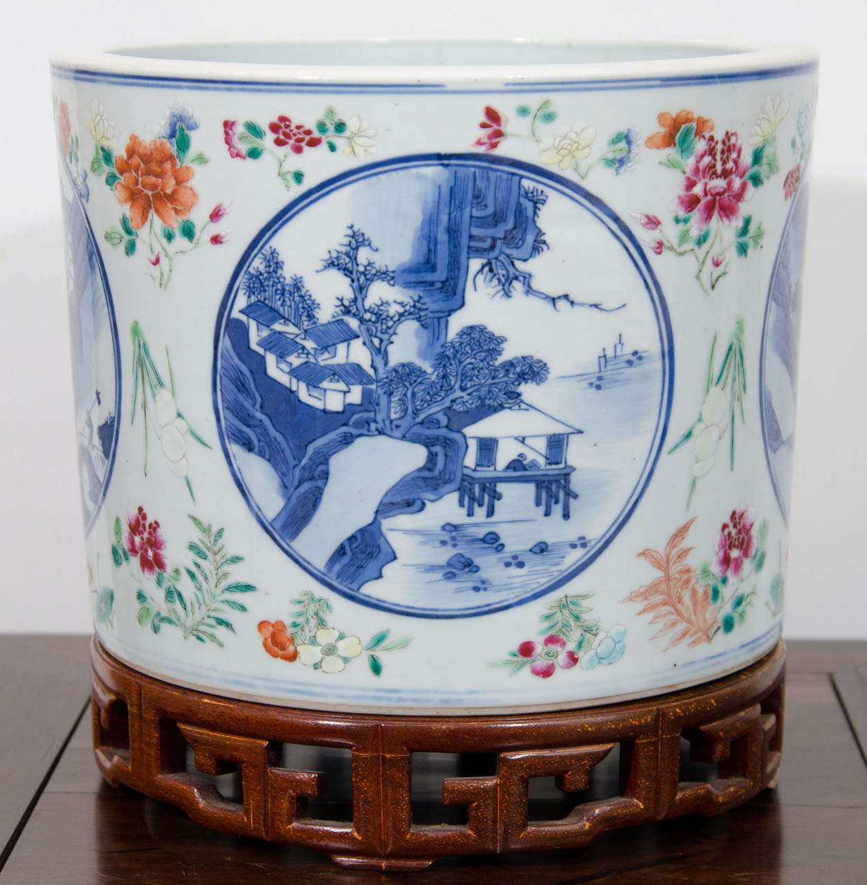 A large 19th Century Guangxu Period Chinese porcelain planter in brush holder shape (bitong) on a hardwood stand.  Hand painted in underglaze blue, there are four roundels depicting the 