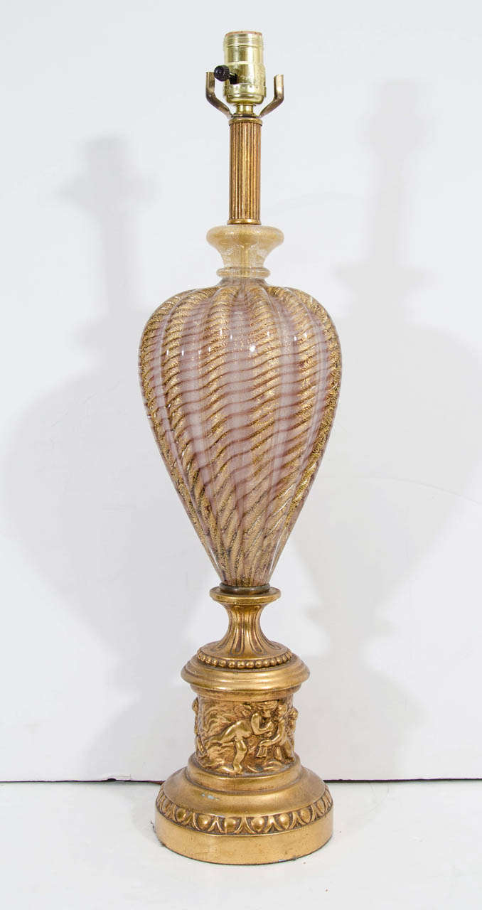 A vintage pair of lilac and gold infused swirled Murano Barovier and Toso glass table lamps.  The base has cherub decor. Some wear to the gilt.

Reduced from: $4,750