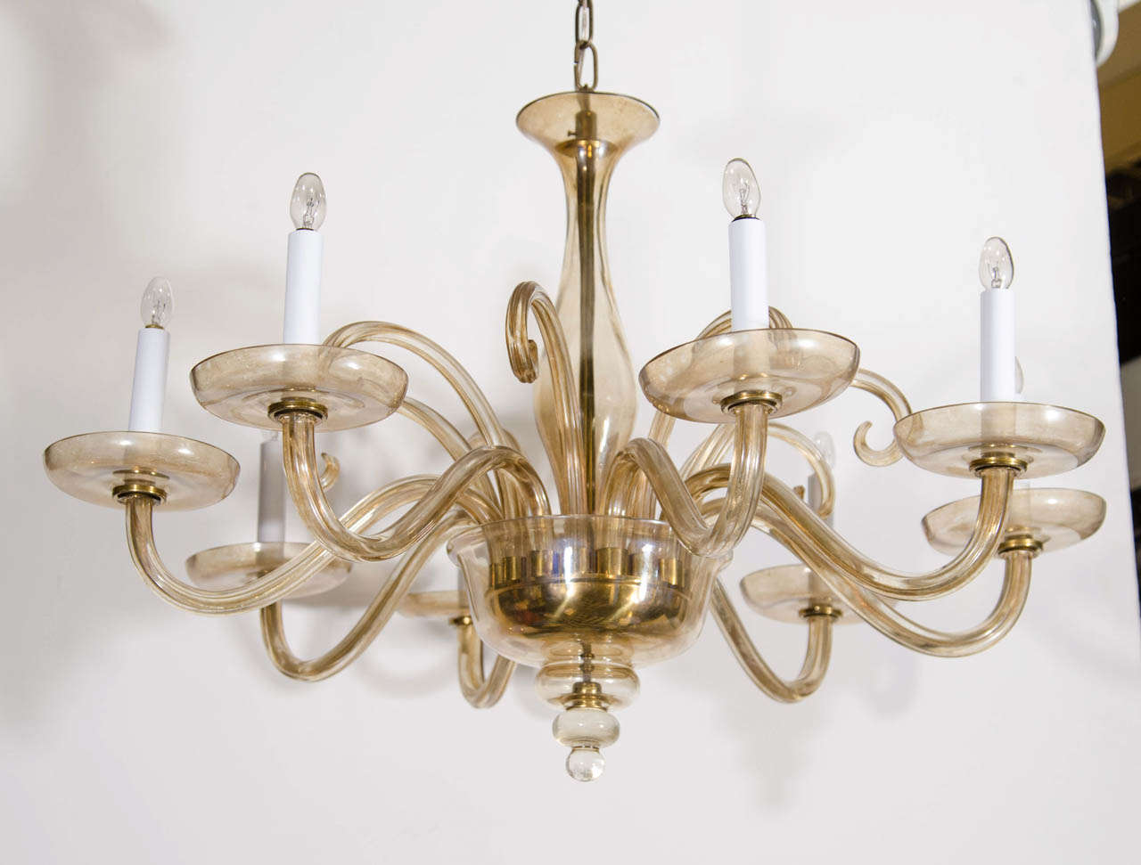 A Vintage eight-arm smokey/amber colored Murano glass chandelier.

As is condition.  One of the arms is broken.